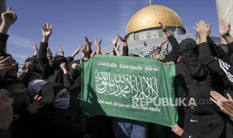 Warga Palestina memegang bendera Hamas (ilustrasi). Kelompok Hamas meminta warga Palestina untuk menghadang parade pengibaran bendera yang direncanakan oleh kaum nasionalis Yahudi. Parade ini akan melalui jalan raya utama Palestina di Kota Tua Yerusalem pada Kamis (18/5/2023).