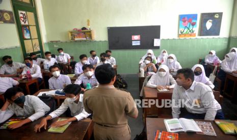 Siswa mengikuti pembelajaran tatap muka (PTM) di SMPN 2 Yogyakarta, Senin (24/1/2022). Mulai 24 Januari Pemkot Yogyakarta mulai menerapkan PTM 100 persen. Sebanyak 659 siswa SMPN 2 Yogyakarta mengikuti PTM 100 persen ini. Namun, setiap sesi pelajaran hanya 30 menit dan hanya 6 jam di sekolah. Kantin juga tidak dibuka sehingga siswa membawa bekal sendiri.