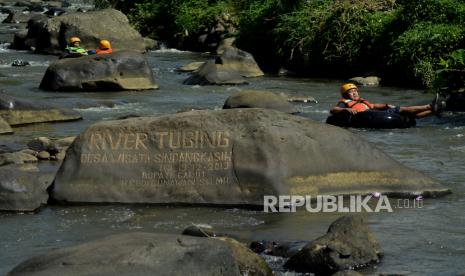 Kunjungan Wisatawan ke Garut Masih Sepi. Foto:  Pengunjung menyusuri aliran sungai menggunakan ban di Desa Wisata Sindangkasih, Cilawu, Kabupaten Garut, Jawa Barat, Ahad (14/3/2021). Destinasi wisata pedesaan yang dikelola oleh masyarakat tersebut menawarkan petualangan menyusuri sungai, spot foto, wahana bermain anak dan rumah kayu bagi pengunjung guna meningkatkan ekonomi warga setempat. 