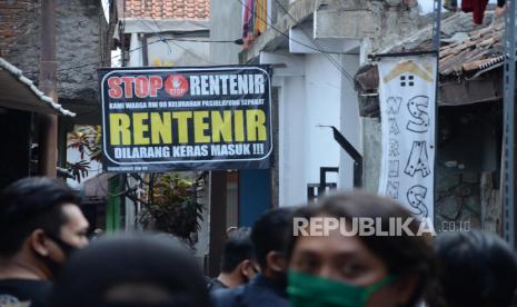 Sebuah sepanduk larangan rentenir dipasang di tengah jalan warga, di Kampung Tangguh Lembur Tohaga Lodaya RW 8, Kelurahan Pasirlayung, Kota Bandung, Senin (3/8). Ekonom Institute for Development of Economics and Finance (Indef) Eko Listiyanto menilai kehadiran perusahaan induk (holding) BUMN ultra mikro dapat melepaskan pelaku usaha sektor tersebut dari jeratan rentenir.