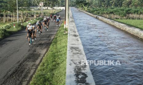 Pesepeda mengayuh sepedanya melintasi area persawahan di Sleman, DI Yogyakarta, Ahad (28/3/2021). Sejumlah operator wisata di Yogyakarta menawarkan paket wisata bersepeda menyusuri suasana pedesaan dan area persawahan sebagai upaya membangkitkan pariwisata. 