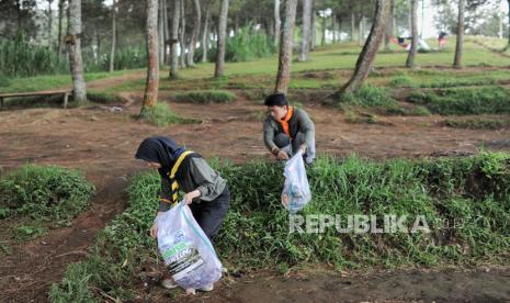 Peserta memungut sampah dalam kegiatan aksi Bebersih Leuweung di Gunung Putri, Jayagiri, Lembang, Jawa Barat, Sabtu (4/8/2024). 