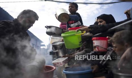 Palestinians line up for a free meal in Rafah, Gaza Strip, Friday, Feb. 16, 2024. International aid agencies say Gaza is suffering from shortages of food, medicine and other basic supplies as a result of the war between Israel and Hamas. 