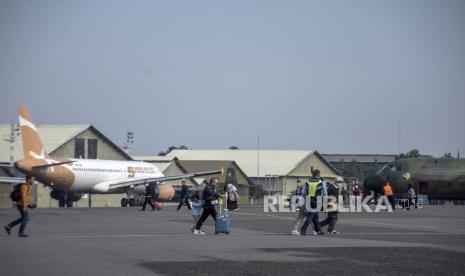 Calon penumpang berjalan menuju pesawat terbang di Bandara Husein Sastranegara, Kota Bandung, Jawa Barat, Kamis (13/7/2023). Presiden Joko Widodo mengatakan penerbangan dari Bandara Husein Sastranegara akan beralih ke Bandara Internasional Kertajati mulai OKtober 2023. Keberadaan dua bandara yang beroperasi ini untuk saling mendukung satu sama lain, serta optimal untuk menunjang dilakukannya penataan rute penerbangan di Jawa Barat.