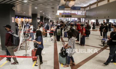 Calon penumpang mengantre di loket check in Bandara Internasional Juanda Surabaya di Sidoarjo, Jawa Timur, Kamis (24/12/2020).  Menurut data pengelola bandara Juanda, jumlah penumpang pesawat udara pada mudik libur Natal mencapai 25.676 ribu penumpang atau menurun 54,06 persen dibandingkan tahun 2019 yang mencapai 55.885 ribu penumpang. 