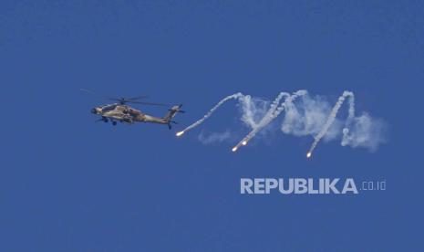 Helikopter militer Israel melepaskan suar di perbatasan Israel-Gaza terlihat dari Israel selatan, Senin, 4 Desember 2023.