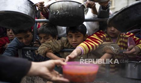 Palestinians line up for a free meal in Rafah, Gaza Strip, Friday, Feb. 16, 2024. International aid agencies say Gaza is suffering from shortages of food, medicine and other basic supplies as a result of the war between Israel and Hamas. 