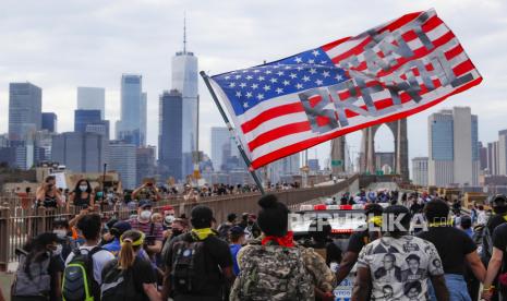  Para pengunjuk rasa berbaris di Jembatan Brooklyn setelah demonstrasi akbar di Cadman Plaza Park, Kamis, 4 Juni 2020, di New York. Aksi unjuk rasa diduga berperan dalam membuat masifnya penyebaran virus corona di AS.