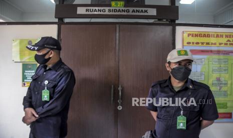 Petugas berjaga di depan ruang sidang anak saat sidang lanjutan kasus pemerkosaan terhadap 13 santri dengan terdakwa Herry Wirawan di Pengadilan Negeri (PN) Kelas IA Bandung, Jalan LLRE Martadinata, Kota Bandung, Selasa (21/12). Dalam sidang lanjutan yang beragendakan pemeriksaan sejumlah saksi anak tersebut Kepala Kejaksaan Tinggi (Kajati) Jawa Barat Asep N Mulyana turut hadir menjadi Jaksa Penuntut Umum (JPU). Foto: Republika/Abdan Syakura