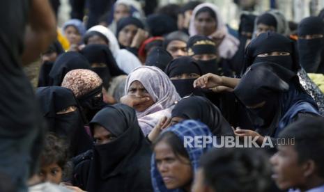 Rohingya refugees rest in an open area after landing on a beach at Blang Ulam Village, Aceh Besar, Indonesia, 10 December 2023.