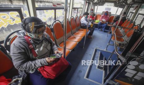 Penumpang duduk di dalam bus milik Pemprov DKI Jakarta di Stasiun Bojong Gede, Kabupaten Bogor, Jawa Barat, Senin (15/6/2020). Dinas Perhubungan Provinsi DKI Jakarta menyediakan 50 unit bus sekolah yang akan mengangkut penumpang secara gratis untuk membantu mengurai penumpukan penumpang di stasiun-stasiun transportasi massal kereta api listrik (KRL) jurusan Bogor menuju Jakarta