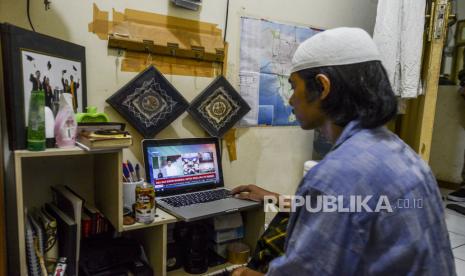 Rais Am PBNU: Berita Gembira Bagi yang Bersabar. Seorang warga menonton siaran Dzikir Nasional secara streaming di Jakarta, Kamis (16/4). Satgas Covid-19 Majelis Ulama Indonesia bersama BNPB, Kantor Wakil Presiden, Kementerian Agama, Kementerian Komunikasi dan Informatika mengadakan Dzikir Nasional yang diselenggarakan secara streaming untuk menolak musibah pandemi Covid-19