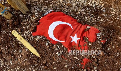  Makam korban gempa bumi yang ditutupi oleh bendera Turki di pemakaman kota setelah gempa bumi dahsyat, di Kahramanmaras, Turki, Ahad (5/3/2023). Lebih dari 50.000 orang tewas dan ribuan lainnya terluka setelah gempa bumi besar melanda Turki selatan dan Suriah utara pada 06 Februari dan lagi pada 20 Februari 2023.