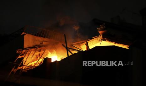 Fire burns at an apartment of an Islamic Jihad commander for northern Gaza, following Israeli airstrikes in Gaza City, early Tuesday, May 9, 2023. Israeli aircraft conducted strikes on Islamic Jihad targets in the Gaza Strip, the Israeli military said. The Palestinian Health Ministry said a number of people were killed and injured in the airstrikes. 