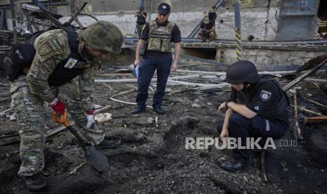 Pihak militer dan polisi mengecek lokasi jatuhnya bom serangan rusia di terminal pos di Kharkiv, Ukraina, Ahad (30/6/2024). Dalam kejadian tersebut setidaknya satu orang tewas dan 10 lainnya terluka, termasuk seorang anak berusia 8 bulan. Kharkiv yang merupakan kota terbesar kedua di Ukraina kerap menjadi sasaran Rusia.