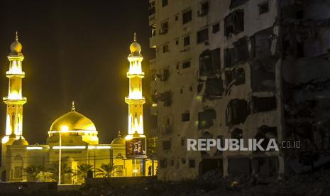 Gaza Bangun Kembali Rumah Hancur Akibat Pengeboman Israel. Foto yang diambil dengan ponsel menunjukkan Masjid Alhasainh di sebelah menara dan rumah yang hancur di Kota Gaza, 26 Juli 2021. Setelah sebelas hari pertempuran selama Mei 2021, gencatan senjata mulai berlaku antara Israel dan militan di Jalur Gaza.