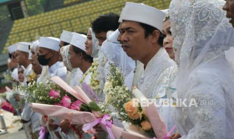 Sejumlah pengantin membawa buket bunga usai mengikuti nikah massal juara di Stadion Patriot Chandrabhaga, Bekasi, Jawa Barat, Minggu (14/5/2023). Pemerintah Provinsi Jawa Barat memfasilitasi kegiatan nikah massal gratis yang sah secara agama dan hukum untuk 300 calon pengantin. 