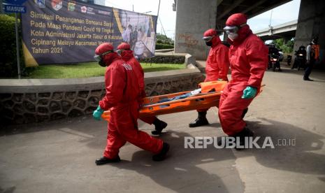 Petugas Gulkarmat mengevakuasi korban banjir saat simulasi penanganan bencana banjir pada masa pandemi Covid-19 di Cipinang Melayu, Jakarta, Rabu (17/11). Simulasi ini digelar dalam rangka kesiapsiagaan petugas dalam penanganan korban banjir, terutama evakuasi warga yang terpapar Covid-19.