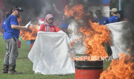 Peserta melakukan pemadaman api saat pemecahan Rekor MURI peragaan pemadaman api dengan personel terbanyak di lapangan Aneka Komperta Plaju, Palembang, Sumatera Selatan, Rabu (10/7/2024). PT Kilang Pertamina International (KPI) menggelar pemecahan Rekor MURI peragaan pemadaman api yang diikuti 1.562 peserta dan dilaksanakan secara serentak di seluruh Refinery Unit (RU) dan anak perusahaan PT KPI dalam rangka memperingati Hari Pemadam Kebakaran Internasional (International Fire Fighters Day) 2024 serta memperluas edukasi kepada publik tentang pentingnya aspek HSSE, terutama bagi komunitas masyarakat. 