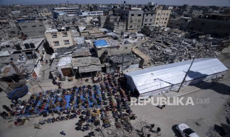 Warga Palestina melaksanakan salat Jumat pertama di bulan suci Ramadhan di dekat reruntuhan masjid yang hancur akibat serangan udara Israel di Rafah, Jalur Gaza, Jumat, 15 Maret 2024.