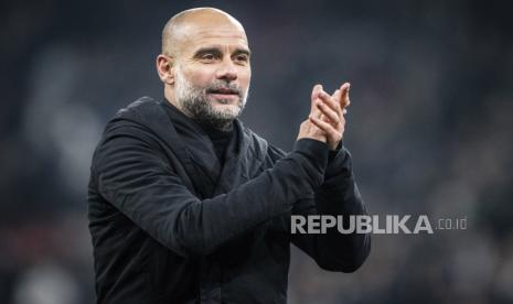 Manchester City head coach Pep Guardiola celebrates after the Champions League, Round of Sixteen first leg, soccer match between FC Copenhagen and Manchester City in Copenhagen, Denmark, Tuesday, Feb. 13, 2024. 