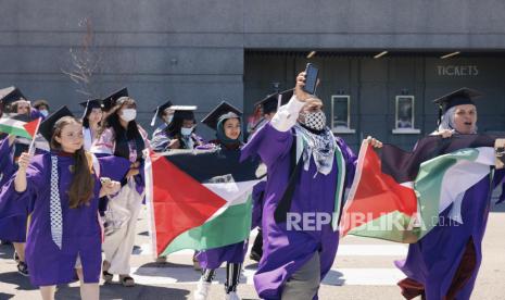 Para wisudawan Universitas Northwestern melakukan aksi walkout saat upacara wisuda sebagai bentuk protes terhadap serangan Israel ke Palestina di United Center, Chicago, Senin (10/6/2024) WIB. Sekitar 50 wisudawan Universitas Northwestern berjalan keluar dari acara wisuda mereka dengan mengenakan kaffiyeh dan mengibarkan bendera Palestina. Mereka bergabung dengan puluhan mahasiswa lainnya yang menunggu di luar arena untuk melakukan upacara berkabung guna menghormati mahasiswa di Gaza yang tewas akibat serangan Israel.