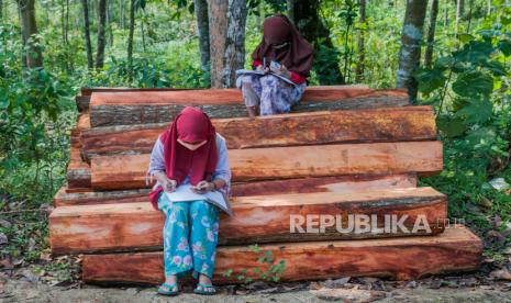 Sejumlah siswa SDN 1 Inten Jaya mengerjakan tugas melalui gawainya di Kampung Lebak Limus, Lebak, Banten, Senin (20/7/2020). Sejumlah siswa yang tinggal di daerah pelosok tersebut kesulitan dalam mengikuti kegiatan belajar mengajar (KBM) secara daring dan tepaksa menempuh perjalanan hingga satu kilometer dari kediamannya menuju ke dataran yang lebih tinggi agar mendapatkan jaringan internet guna mengerjakan tugas sekolah melalui gawai yang nantinya dikirim melalui aplikasi percakapan WhatssApp. 