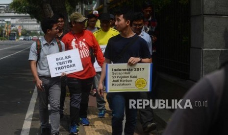 Koalisi Pejalan Kaki melakukan aksi Tamasya Trotoar Kita di Jalan Medan Merdeka Selatan, Jakarta.