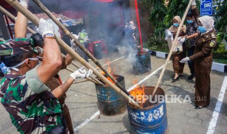 Petugas memusnahkan barang bukti narkoba.