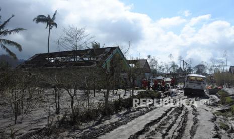 Relawan kemanusian membantu  mengamankan barang yang bisa diselamatkan dari rumah yang rusak akibat awan panas guguran Gunung Semeru di Dusun Kajarkuning, Desa Sumberwuluh, Lumajang, Jawa Timur, Kamis (9/12/2021). Warga terdampak awan panas guguran Gunung Semeru tetap menyelamatkan barang berharga dari rumah mereka yang rusak dan tertimbun abu vulkanik sambil dibantu relawan kemanusiaan. 