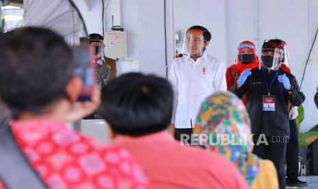 Presiden Joko Widodo (kiri) bersama Bupati Banyuwangi Abdullah Azwar Anas (kanan) menyapa warga di Pasar Pelayanan Publik Rogojampi, Banyuwangi, Jawa Timur, Kamis (25/6/2020). Kunjungan kerja kepresidenan di masa adaptasi kebiasaan baru itu untuk meninjau kesiapan pelayanan publik dan sektor pariwisata. 