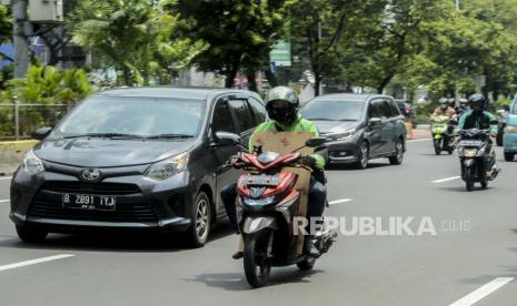 Sejumlah pengemudi ojek online membawa barang pesanan di Jalan Kramat Raya, Senen, Jakarta, Senin (13/4). Masih belum jelasnya regulasi antara Peraturan Menteri Perhubungan dan Peraturan Menteri Kesehatan terkait diperbolehkanya ojek online membawa penumpang selama masa Pembatasan Sosial Berskala Besar (PSBB) membuat pengemudi ojek online hanya bisa membawa barang pesanan selama masa pandemi COVID-19