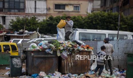  Anak-anak mencari barang berharga di tempat sampah di samping pasar di Beirut, Lebanon, Senin, 12 April 2021. 