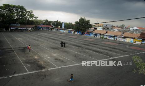 Warga berjalan di area parkiran bus yang kosong di Terminal Cicaheum Bandung, Bandung, Jawa Barat, Kamis (6/5/2021). Pelayanan perjalanan Bus Antar Kota Antar Provinsi (AKAP) dan Antar Kota Dalam Provinsi (AKDP) di Terminal Cicaheum tersebut sudah dihentikan beroperasi terkait pemberlakuan larangan mudik lebaran 1442 H mulai 6-17 Mei 2021 oleh Pemerintah Indonesia. 