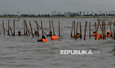 Personil TNI AL bersama warga membongkar pagar laut di Perairan Tanjung Pasir, Kabupaten Tangerang, Banten, Sabtu (18/1/2025). TNI Angkatan Laut bersama dengan nelayan membongkar pagar laut misterius sepanjang 30,16 km di Kabupaten Tangerang, secara manual. Pembongkaran pagar laut dipimpin langsung oleh Komandan Pangkalan Utama AL (Danlantamal) III Jakarta Brigadir Jenderal (Mar) Harry Indarto.