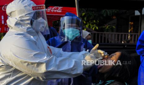 Petugas medis mengambil sampel lendir dari bagian belakang hidung dan tenggorokan seorang warga di Kayuringin Jaya, Bekasi, Jawa Barat, Jumat (15/5/2020). Tes swab yang dilakukan secara random sebanyak 50 sampel tersebut diperuntukkan untuk warga yang melangggar aturan Pembatasan Sosial Berskala Besar dan pedagang takjil