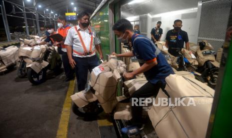 Pekerja membongkar muatan angkutan motor gratis (MOTIS) di Stasiun Lempuyangan, Yogyakarta, Kamis (28/4/2022). 