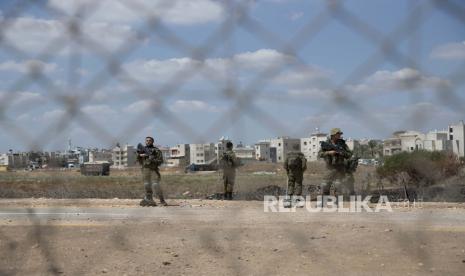  Tentara Israel Bunuh Warga Palestina di Tepi Barat. Foto: Tentara Israel berjaga di dekat bagian pagar pemisah Israel yang rusak, yang digunakan oleh pekerja Palestina untuk menyeberang ke Israel, di desa Jalameh, Tepi Barat, dekat Jenin, Senin, 6 September 2021. Israel melancarkan perburuan besar-besaran di utara negara itu dan Tepi Barat yang diduduki Senin pagi setelah enam tahanan Palestina keluar dari sel mereka dan melarikan diri semalam dari fasilitas keamanan tinggi dalam pelarian yang sangat langka.