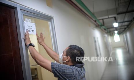 Petugas memasang stiker di ruang isolasi pasien Covid-19 di Rumah Susun Nagrak, Cilincing, Jakarta Utara, Senin (21/6). Satuan Tugas Covid-19 memastikan kesiapan Rusun Nagrak Cilincing telah mencapai 100 persen untuk dijadikan tempat isolasi mandiri pasien Covid-19 dengan status Orang Tanpa Gejala (OTG) per hari ini 21 Juni 2021. Republika/Thoudy Badai