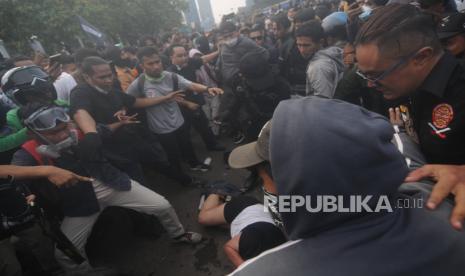 Pegiat Media Sosial Ade Armando dipukuli massa saat terjadi kericuhan di depan Gedung DPR, Jakarta, Senin (11/4/2022). Aksi unjuk rasa yang berujung ricuh tersebut dibubarkan oleh aparat kepolisian dengan menembakan gas air mata dan water canon. Republika/Putra M. Akbar