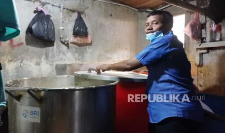 Joko Asori sedang mengukus kacang kedelai yang merupakan bahan utama dalam membuat keripik tempe.