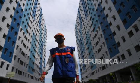 Petugas BPBD DKI Jakarta melintas di Rumah Susun Nagrak, Cilincing, Jakarta Utara, Selasa (15/6/2021). Pemprov DKI Jakarta mengurangi kapasitas  tempat tidur di rusun tersebut menyusul berkurangnya pasien Covid-19.