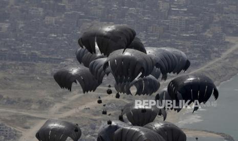 Kontainer bantuan kemanusiaan dijatuhkan dari udara ke warga Palestina di Jalur Gaza dari pesawat Angkatan Udara C-17 AS, Jumat, (29/3/2024).