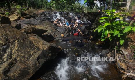 Sejumlah wisatawan bermain di objek wisata air terjun (ilustrasi)