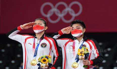 Pebulutangkis ganda Putri Indonesia peraih medali emas Greysia Pollii/Apriyani Rahayu hormat saat pengibaran bendera Merah-Putih usai menjuarai final Olimpiade Tokyo 2020 di Musashino Forest Sport Plaza, Tokyo, Jepang, Senin (2/8/2021). Greysia Pollii/Apriyani Rahayu meraih medali emas setelah mengalahkan ganda putri China Chen Qing Chen/Jia Yi Fan 21-19 dan 21-15. 