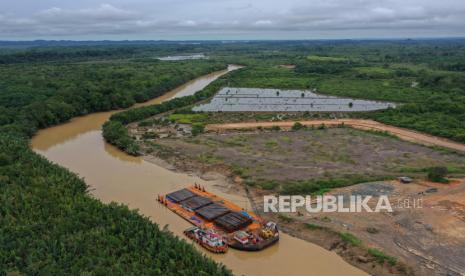 Foto udara sebuah kapal tongkang pengangkut material logistik untuk proyek pembangunan Ibu Kota Negara (IKN) Nusantara kandas di pelabuhan masyarakat Desa Bumi Harapan, Kecamatan Sepaku, Kabupaten Penajam Paser Utara, Kalimantan Timur, Jumat (24/2/2023). Pelabuhan yang menjadi salah satu jalur pengiriman material dan logistik untuk pembangunan IKN Nusantara tersebut mengalami kendala ketika air sungai surut yang mengakibatkan kapal rawan kandas. 