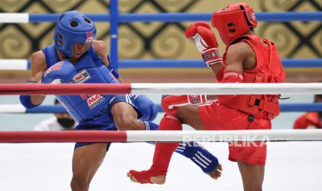 Atlet Muay Thai Papua Abdurahman (kiri) saling serang dengan atlet Muay Thai Banten Sulaiman (kanan) pada penyisihan Muay Thai kelas 48 Kg Putra PON Papua di GOR STT Gidi, Sentani, Papua, Selasa (28/9/2021). 