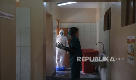 Dokter mendisinfeksi diri mereka sendiri setelah mengunjungi pasien yang kontak dengan korban Ebola, di bagian isolasi Rumah Sakit Rujukan Regional Entebbe di Entebbe, Uganda Kamis, 20 Oktober 2022. Wabah Ebola di Uganda