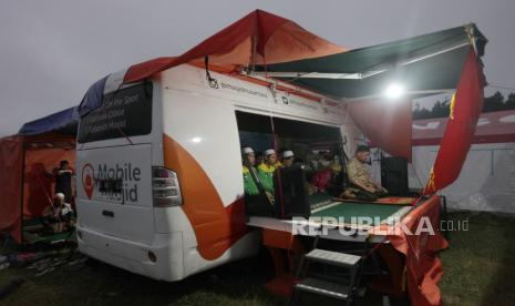 PMI Fokus Distribusi Air Bersih dan Layanan Kesehatan Korban Semeru. Sejumlah pengungsi korban erupsi Gunung Semeru melaksanakan ibadah shalat maghrib di fasilitas mushola mobile yang ada di posko pengungsi lapangan Penanggal, Kabupaten Lumajang, Jawa Timur, Kamis (9/12). Adanya fasilitas tersebut membantu para pengungsi dalam melaksanakan ibadah.