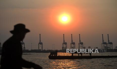 Pelabuhan Kalibaru saat senja terlihat dari tanggul pantai Kalibaru di Cilincing, Jakarta Utara, Senin (29/8/2023).